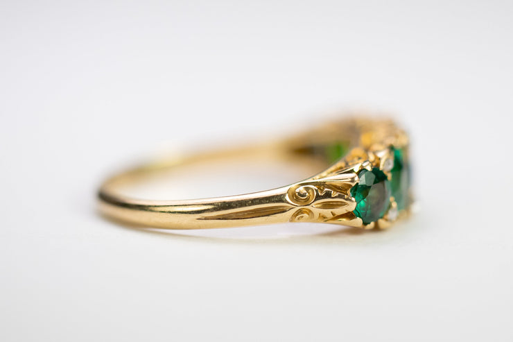 Victorian 18k 2.34 CTW Emerald Paste and Rose Cut Diamond Five Stone Ring with Scrolling Gallery and Fleur-De-Lis Shoulders