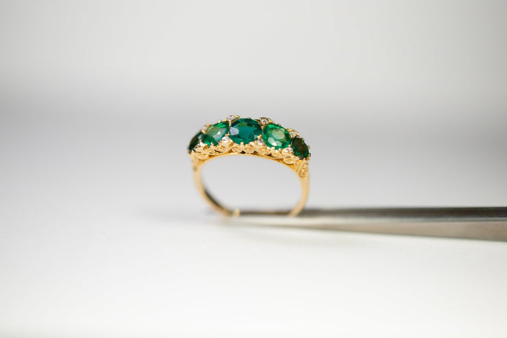 Victorian 18k 2.34 CTW Emerald Paste and Rose Cut Diamond Five Stone Ring with Scrolling Gallery and Fleur-De-Lis Shoulders