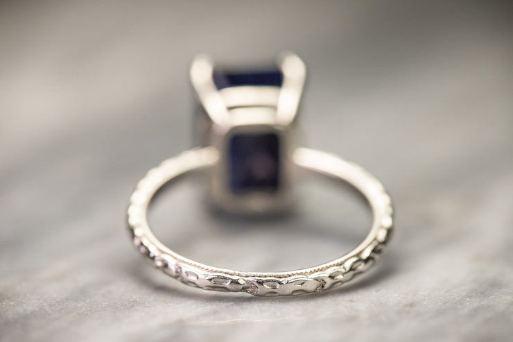 Art Deco Platinum 3.35 CT Emerald Cut Sapphire Ring with Milgrain and Raised Floral Eternity Shank