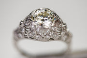 Early 20th Century Platinum 1.80 CTW VS2 Transitional Cut Diamond Art Deco Engagement Ring with Domed Floral Filigree and Etched Band