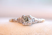 1940s 14k Palladium 0.19 CTW Fancy Light Brownish Yellow Diamond Three Stone Engagement Ring