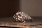 Early 20th Century Platinum 1.80 CTW VS2 Transitional Cut Diamond Art Deco Engagement Ring with Domed Floral Filigree and Etched Band